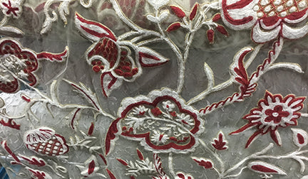 Embroidered sheer fabric with a cream and red floral design from Len's Designer Fabric Store in Toronto