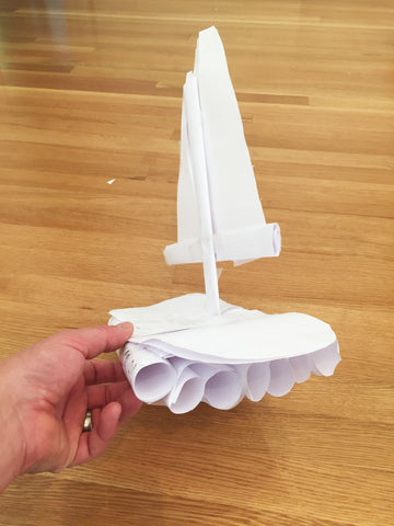 Image of paper sailboat mock up built by my son. The hull is constructed from several rolled up pieces of paper, taped together