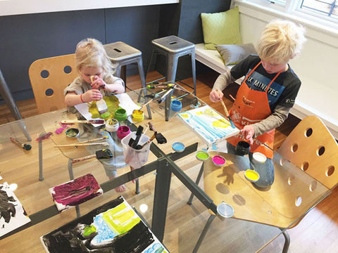 Image of two young children using colorful paints on the Eric Jacoby Design Tectonic Dining Table