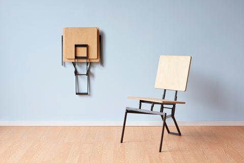 modern folding chair that can be hung on a wall