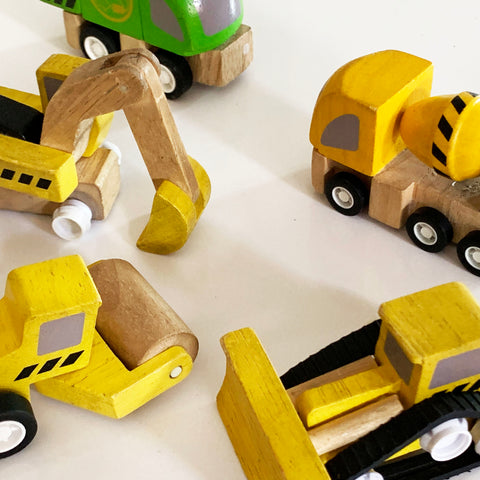 five wooden Plan City trucks which have been repaired