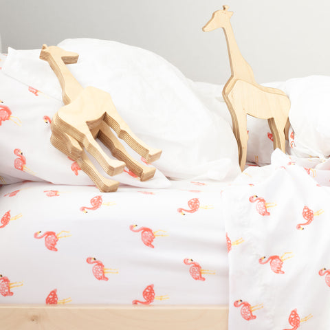baby wooden giraffes in bed