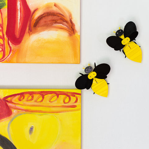 sculptural bees and modern yellow paintings
