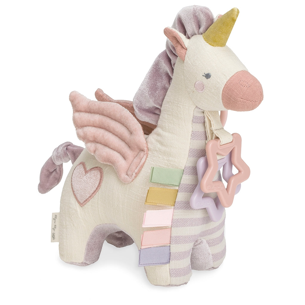 Itzy Ritzy activity plush pegasus with teether toy against white backdrop