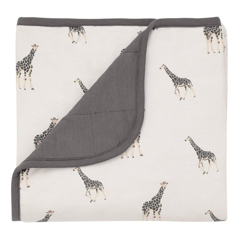 Kyte Baby giraffe baby blanket against white backdrop