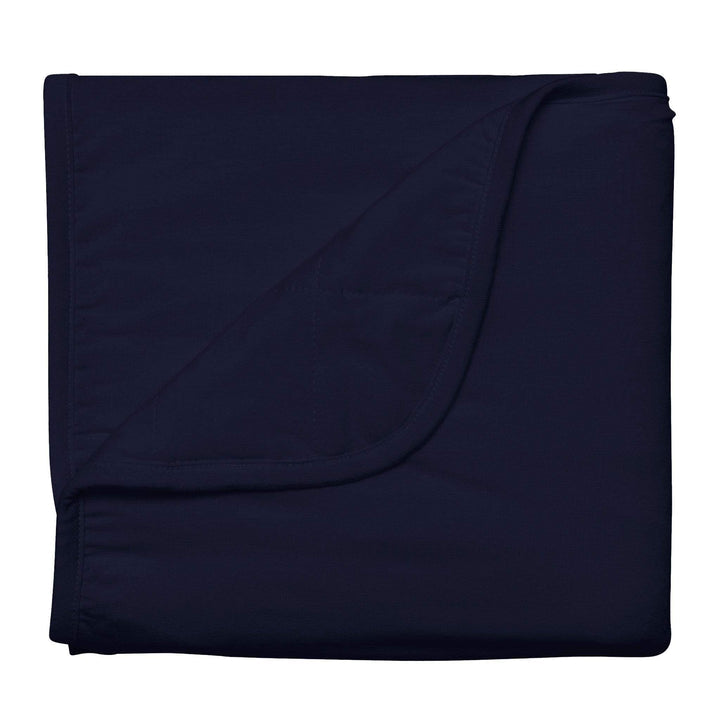 Kyte Baby navy baby blanket against white backdrop