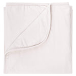 Kyte Baby oat baby blanket against white backdrop