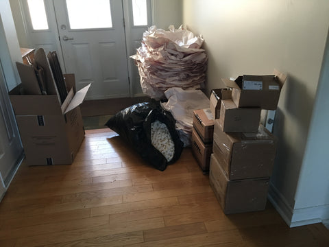 Boxes, bags, packing paper, styrofoam peanuts