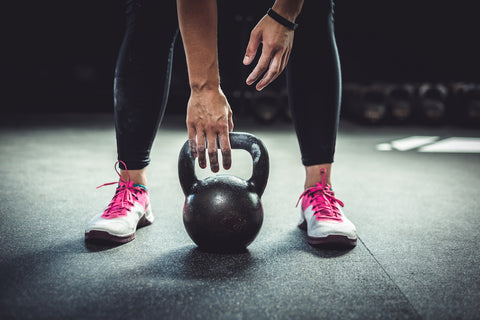 A person working out with a kettlebell.