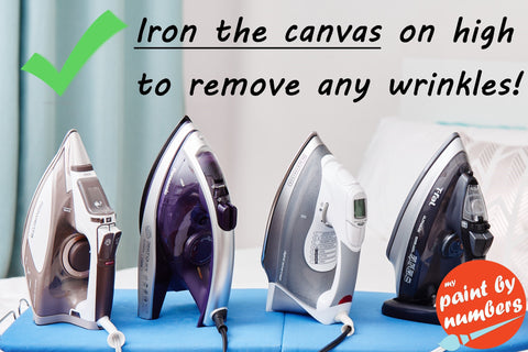 Iron and ironing board to remove wrinkles from canvas