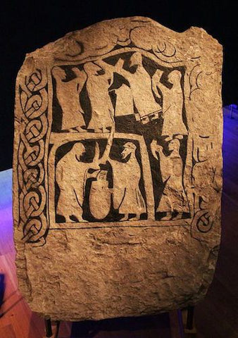 Viking stone depicting people feasting and drinking in the drinking horn 