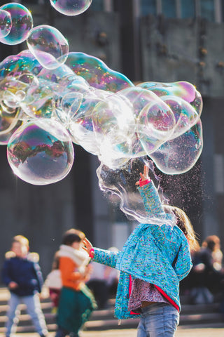 blowing massive bubbles by Alexander Dummer on Unsplash