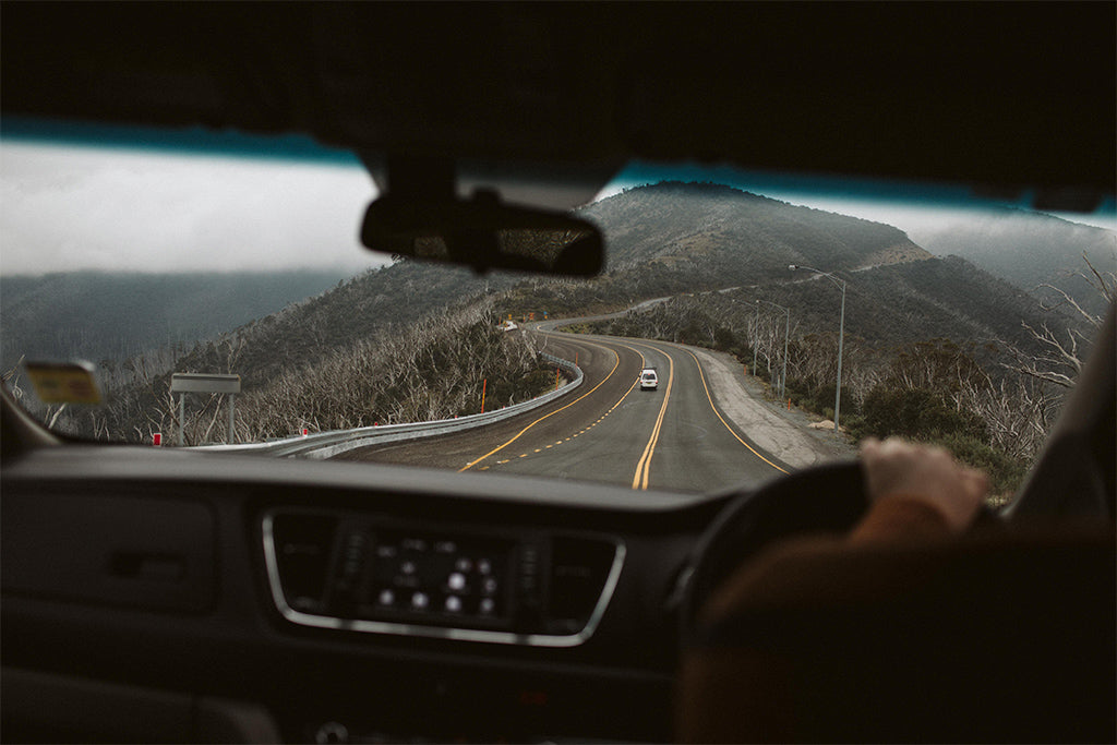 A view of the winding road ahead from inside a car 