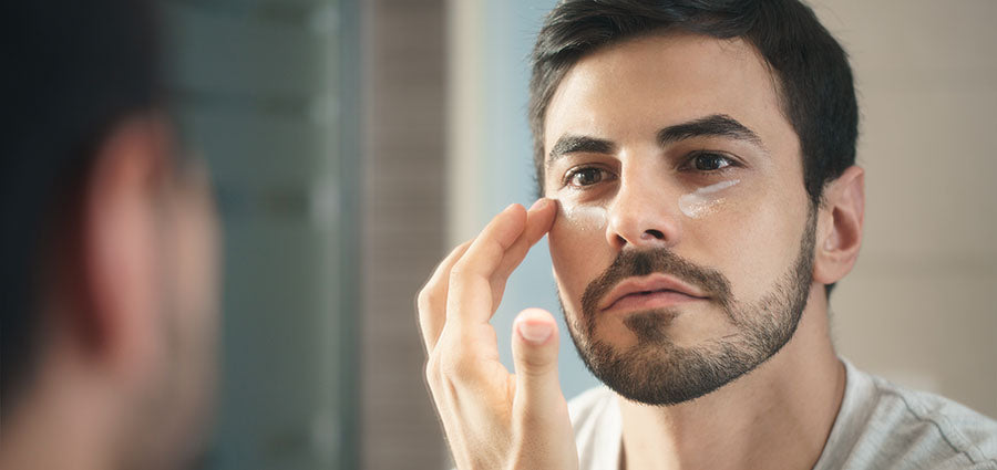 Man checking skin around his eyes. cbd eye cream. Buy eye cream with cbd. Hemp cbd cream for eczema around eyes. Does cbd eye cream work?