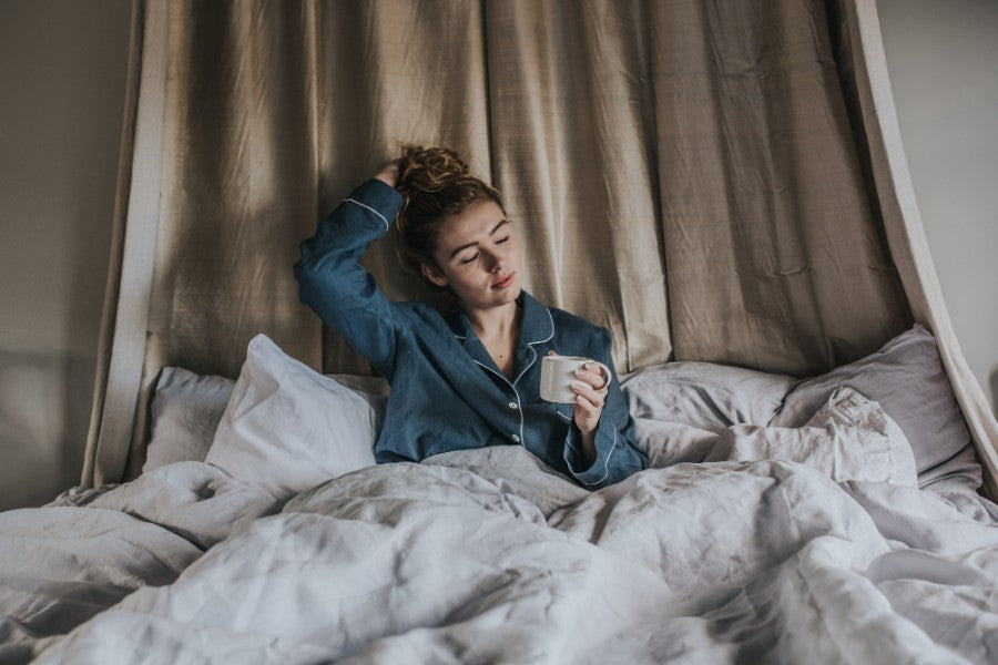Girl enjoying a cup of tea in bed using a Barton Croft mug