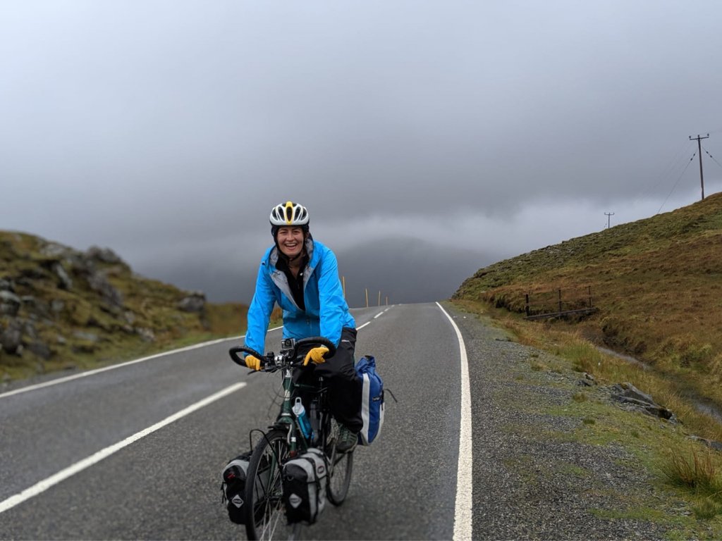 Lucy cycling in rainy Scotland countryside