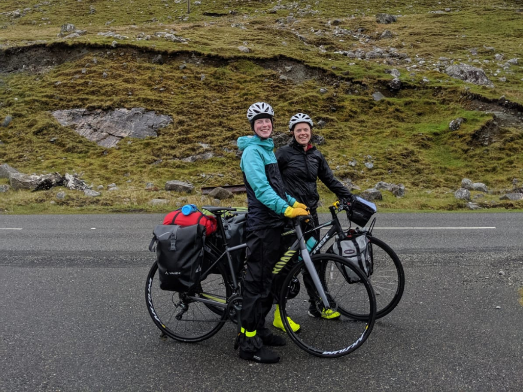 Fiona and Lucy cycling in rainy Scotland mountains