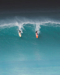 two surfers on sea wave