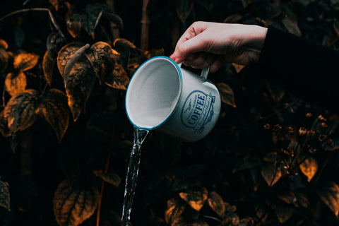 white mug pouring water