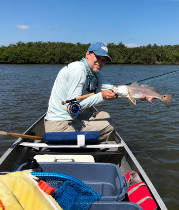 Redfish in canoe caught on fly.