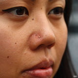 Nostril piercing by Andru