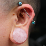 Streched earlobe piercing with plugs