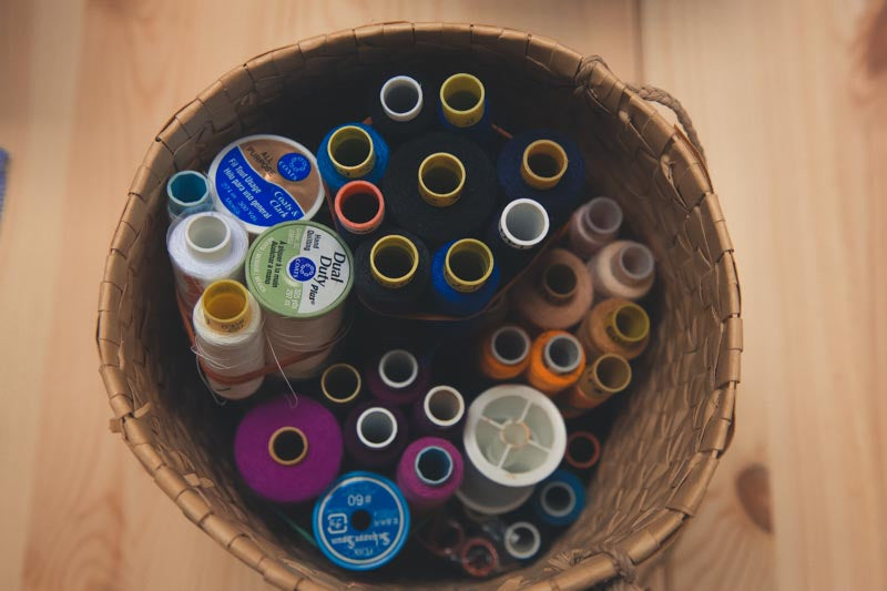 Colourful rolls of thread in a basket
