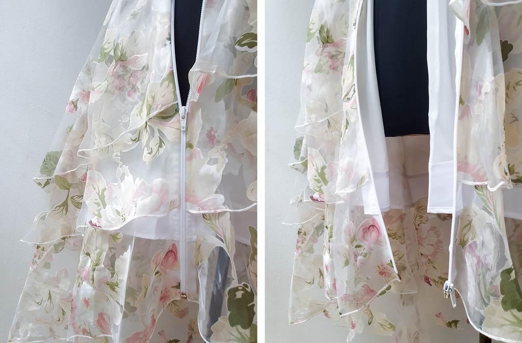 Translucent and layered white dress with floral patterns. Redesigned with open-ended zippers added.