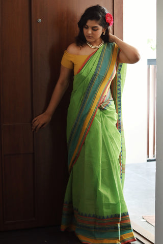 women in a cotton saree standing