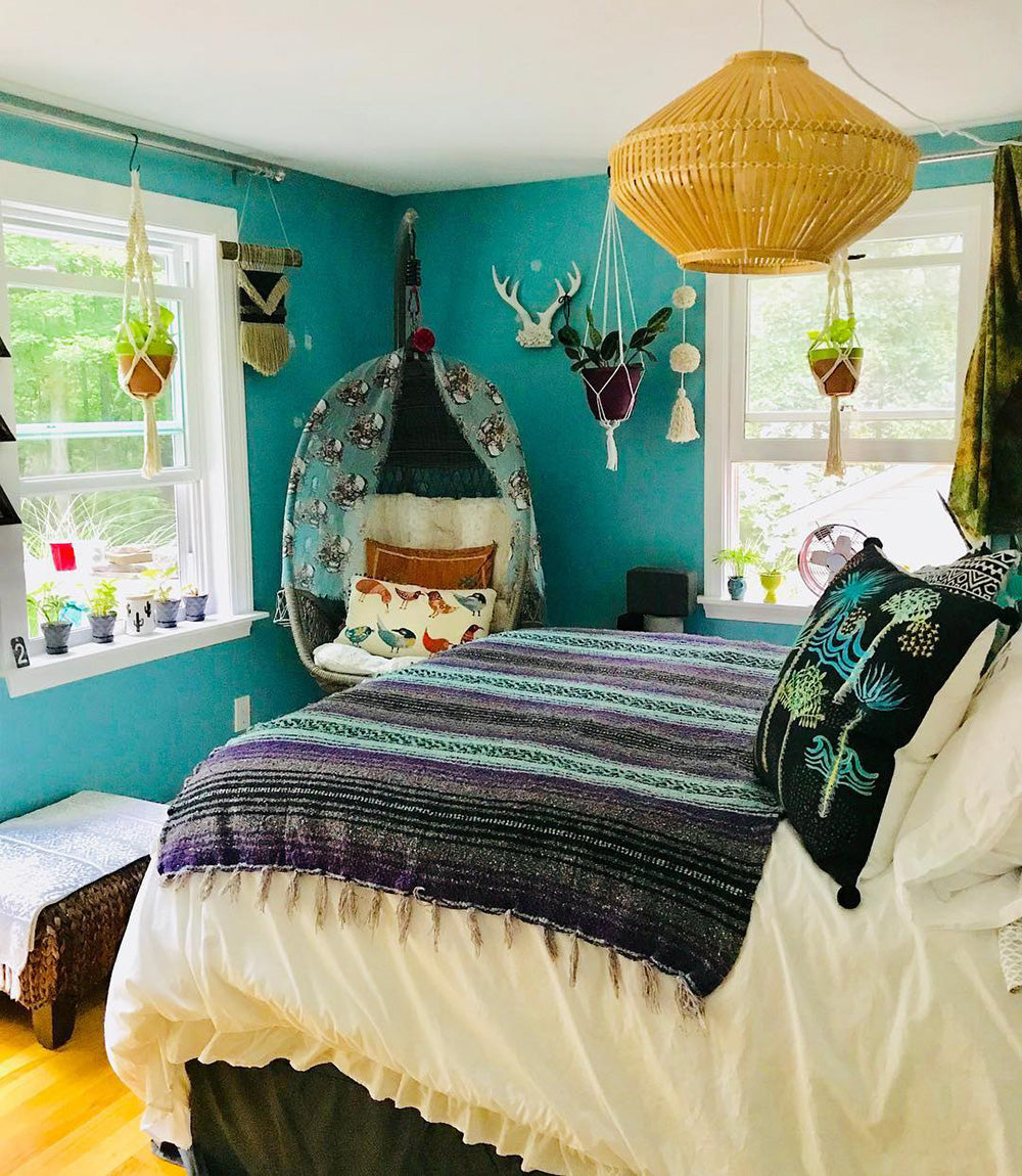 A cozy boho bedroom featuring the Purple Surf Bohemian Fiesta Blanket. These traditional Mexican blankets are perfect for creating a cozy boho look in the bedroom or anywhere else in the home.