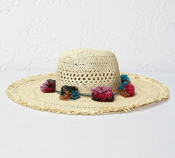 straw hat with colourful pom-poms