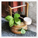green leaves in tea ceremony water bucket