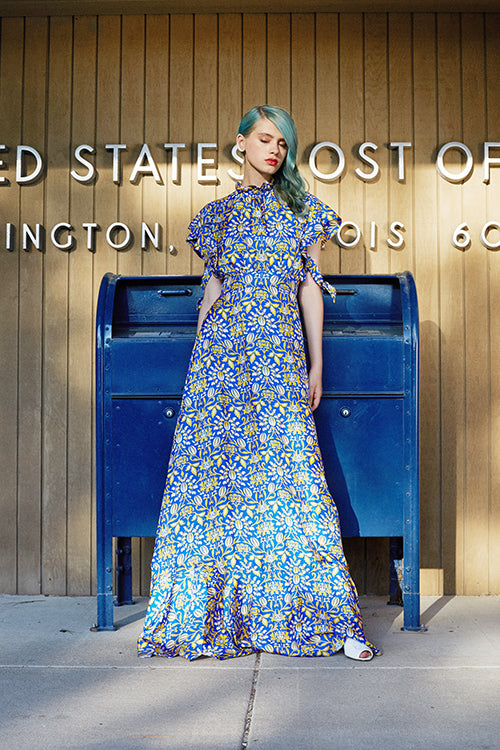 Cynthia Rowley 2019 Resort Collection features a high-collared royal blue and yellow floral printed maxi dress.
