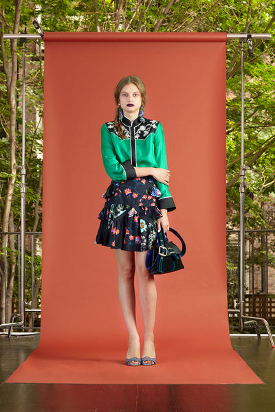 Cynthia Rowley Resort 2017 look 27 featuring a green blouse with a black floral ruffle mini skirt