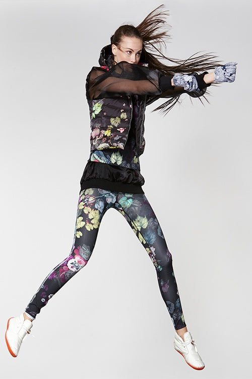Cynthia Rowley Fall Fitness 2015 look 3 featuring dark floral print leggings and quilted down vest, and sheer black sweatshirt