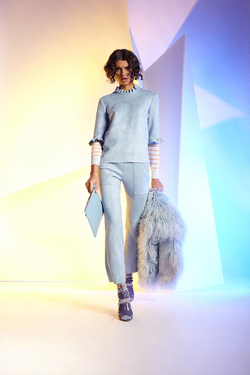 Cynthia Rowley Fall 2016 look 16 featuring baby blue bonded suede cargo flare pants and t-shirt with ruffles worn over a light blue and orange striped sweater