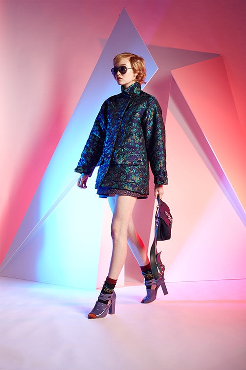 Cynthia Rowley Fall 2016 look 5 featuring a green and blue jacquard short coat worn over a purple jacquard mini skirt