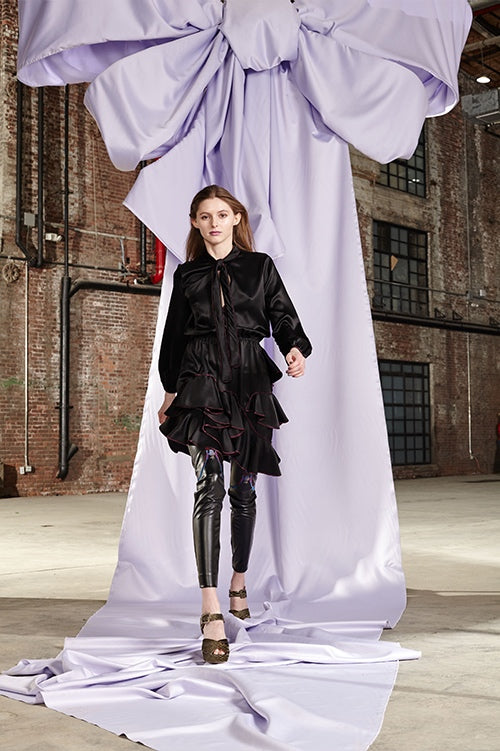 Cynthia Rowley Fall 2017 Look 28 featuring a silk charmeuse long sleeve dress with ruffle skirt worn over black leather leggings