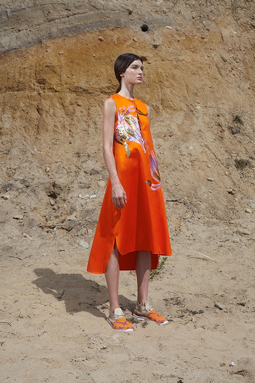 Cynthia Rowley Spring 2016 look 19 featuring an orange polished cotton sleeveless dress with front ties at chest and sequin embellishments 
