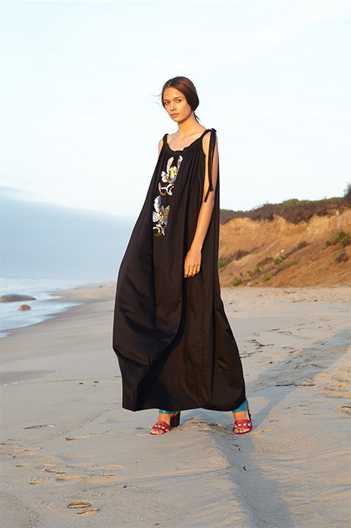 Cynthia Rowley Spring 2016 look 1 featuring a black polished cotton maxi dress with shoulder ties and sequin embellishments
