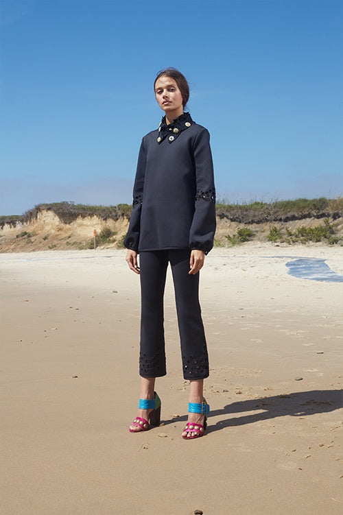 Cynthia Rowley Spring 2016 look 26 featuring black boned nylon cropped flare pants with embroidered dot cutouts and long sleeve top with embellished collar