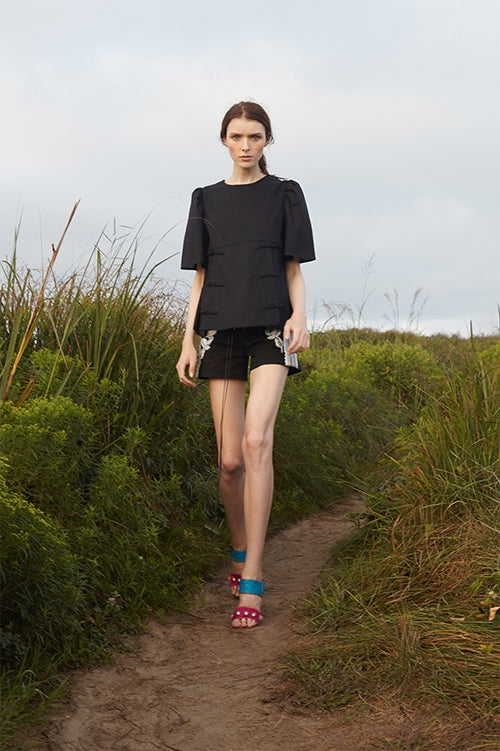 Cynthia Rowley Spring 2016 look 9 featuring black cotton shorts with embroidery and black cotton woven shirt with shirred shoulder and short sleeves