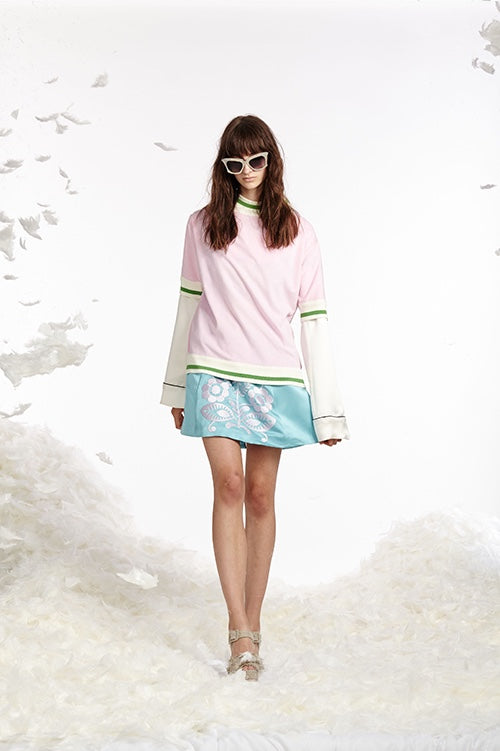 Cynthia Rowley Spring 2017 look 16 featuring an ice blue duchess satin mini skirt with white embroidery worn with a white silk pajama top and light pink and green striped terry cloth t-shirt