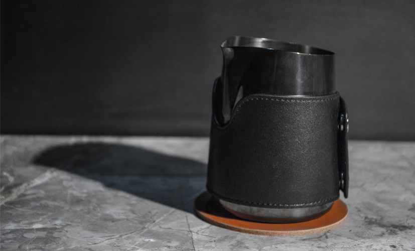Black handleless milk jug