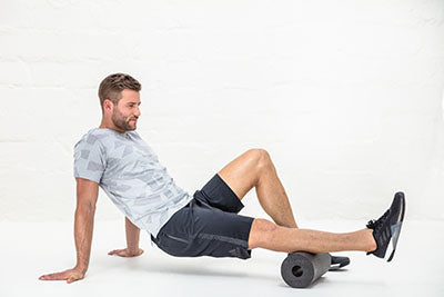 Man rolling out his charley horse and calf with the BLACKROLL Pro Foam Roller
