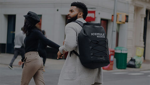 A group of friends walks through the city with their IceMule cooler in tow.