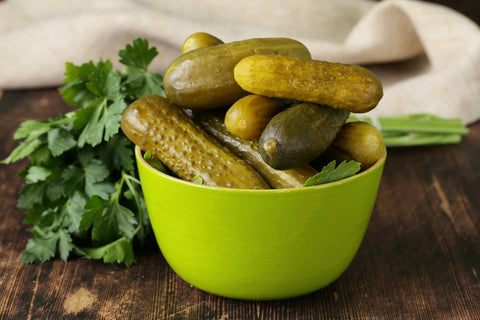 Pickles in a bowl serve as one of many healthy roadtrip snacks.