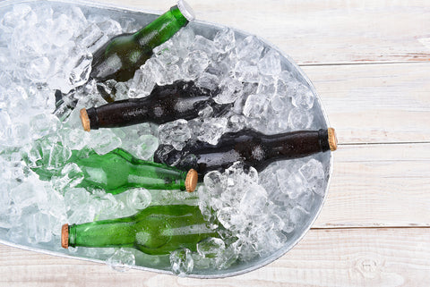 A tin bucket filled with ice and a few beers.