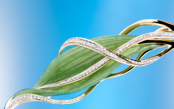Unique richly shape designed golden pendant with briliant cut diamonds and jade carving leaf