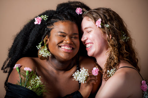 Portrait of Two Models Smiling at Each Ohher 
